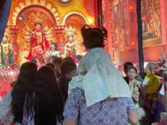 A Father’s Shoulders Offer a Child a Better View of Durga Puja